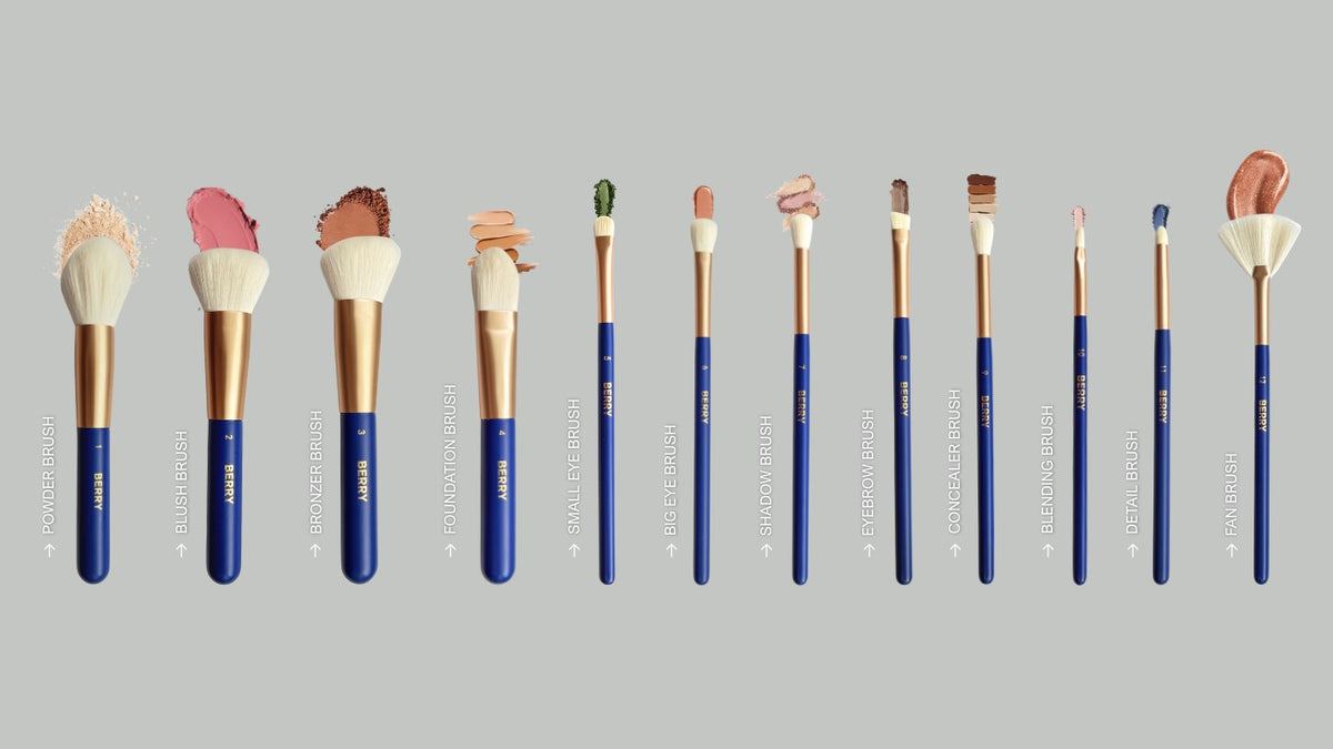 All twelve BERRY GOODS makeup brushes laid out in a row and labelled, from powder brush at number one to fan brush at number twelve