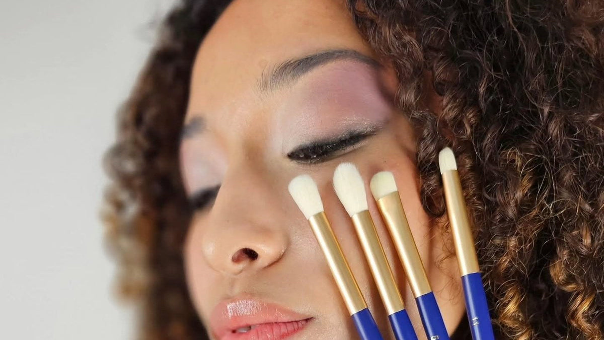 Four BERRY GOODS eye brushes held against a model's cheek, their heads holding a clean tapered shape